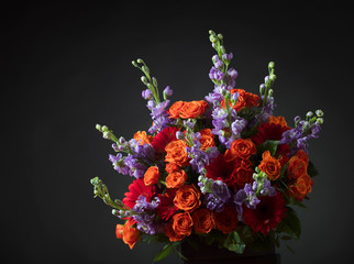Close up of colorful flowers bouquet with red roses and gerbers.