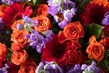 Close up of colorful flowers bouquet with red roses and gerbers.