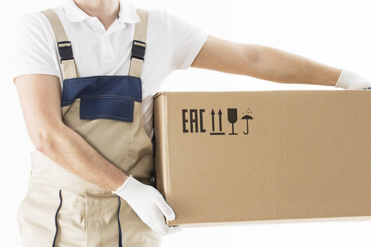Mover holding in hands cardboard box isolated on white background. Relocation services concept. Loader in uniform with box. Worker in gloves with box for moving.