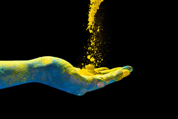 Hand holding colorful powder for holi. Festival of colors