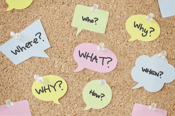 Questions speech bubbles on pinboard