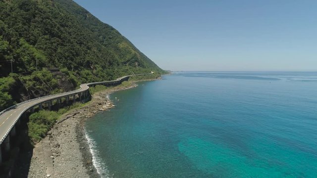 Aerial view of Patapat viaduct in the coast of Pagudpud, Ilocos Norte. Highway with bridge by coast sea near the mountains. Philippines, Luzon. Highway along the coast.