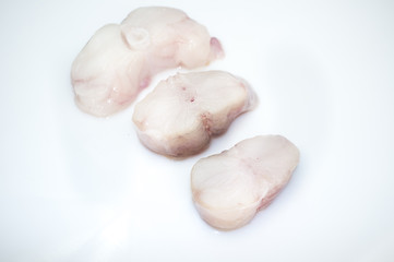 Monkfish tail steaks. Isolated over white