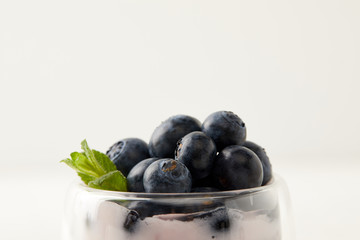 Close up view of pudding with fresh blueberries on grey backdrop