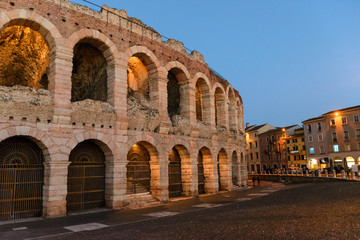 Obraz premium Verona, Italy. Ancient amphitheater Arena di Verona in Italy like Rome Coliseum with nighttime illumination and evening blue sky. Veneto region.
