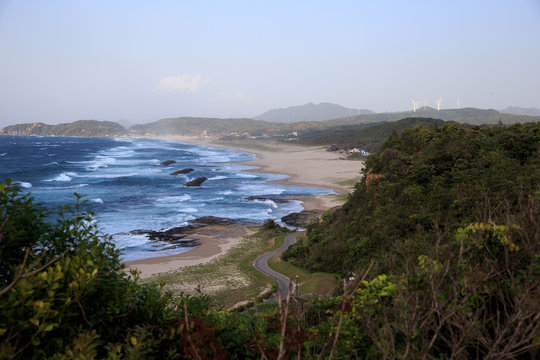 Distant wind turbines behind windswept waves on the Sea of Japan
