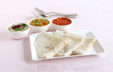 Neer dosa, a south Indian traditional, popular and vegetarian crepe or dish, with coconut and tomato chuntey and vegetable curry as side dishes.