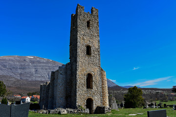 Old grave by the ruins of early pre-romanesque Church of Holy Salvation near small town Vrlika.