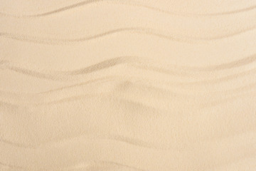 Texture of sandy beach with smooth waves