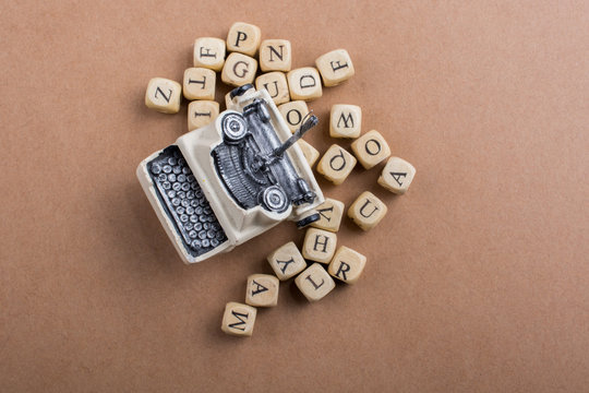 Letter cubes of made of wood around typewritter