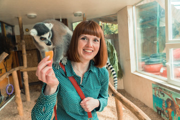 Lemurs. Girl feeds lemurs © liukovmaksym