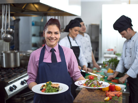 young waitress showing dishes of tasty meals - Powered by Adobe