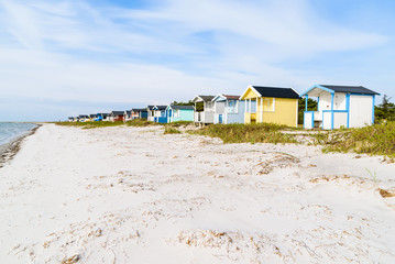 Skanor, Sweden - Long row of colorful bathing sheds along the sandy beach