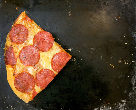  A slice of pizza on a black background