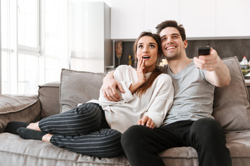 Portrait of a happy young couple relaxing on a couch
