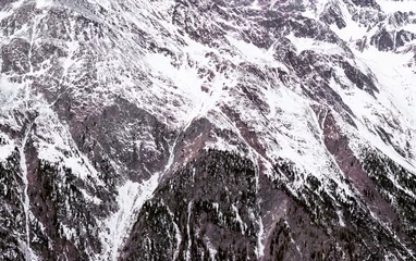 Fotobehang K2 Winter Alpine achtergrond. Het bergachtige terrein in de sneeuw
