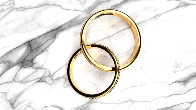 Forever together wedding rings with engraved word 'forever' on a white marble table, symbolize love and staying forever together, close up