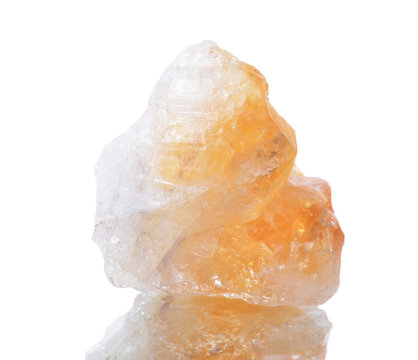 macro shooting of natural mineral rock specimen -  citrine stone on an isolated white background,reflection