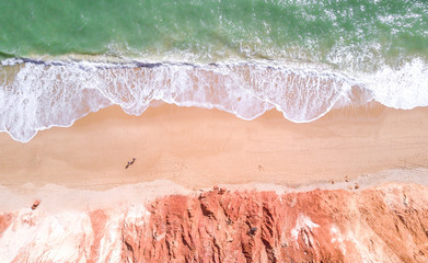 Fototapeta na wymiar Aerial view of sandy beach and ocean with beautiful clear turquoise water.