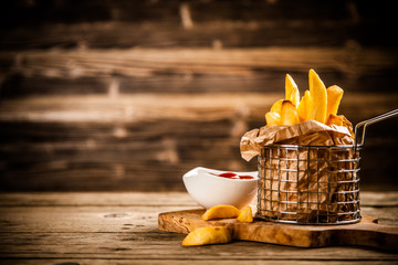 French fries on wooden table - 204217550