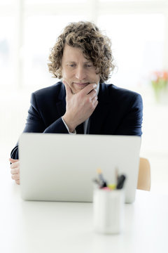 Businessman using laptop at his desk