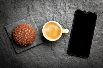 Coffee, dessert and a smartphone