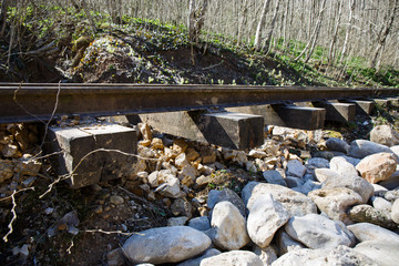 railroad washed away by a mountain stream, railroad hanging in the air