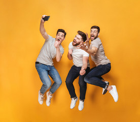 Three young excited men taking a selfie