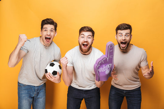 Three young cheery men football fans celebrating