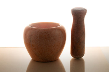 Pestle next to the mortar - tools for making mixtures or grinding products.