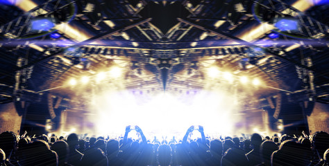 Live event stage lit with people attending the concert