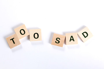 words too sad made of wooden block isolated on white background