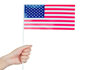 Female hand holding an American flag on a white background. Concept of the Independence Day of America July 4