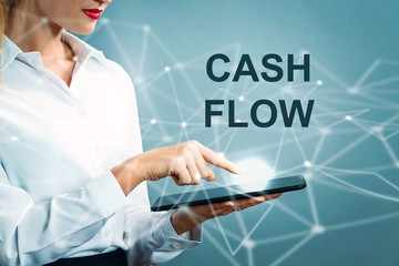 Cash Flow text with business woman using a tablet