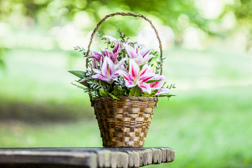 Beautiful bouquet of lilies in a basket