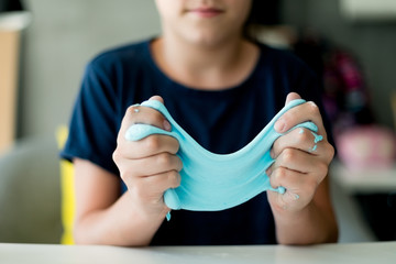 Young girl making a slime