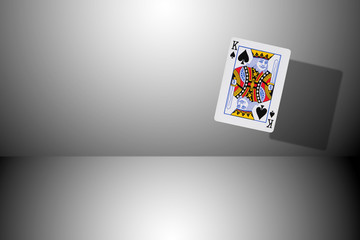 poker card flying on a black and white background with copy space.