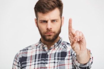 Portrait of a serious young man in plaid shirt