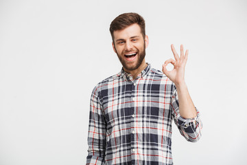 Fototapeta premium Portrait of a cheerful young man in plaid shirt