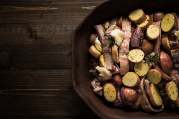 Lamb Loin Chops with Vegetables in Rustic Clay Dish Prepared for Roasting. Copy Space.