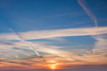 Obraz na płótnie Canvas Orange clouds on the sky at the sunset moment