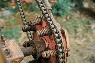 Parts of old broken machine under corrosion closeup. Old technics. Gears, chains.