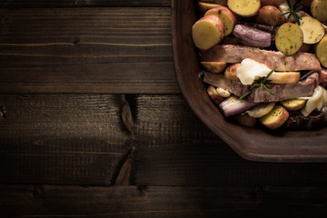 Lamb Loin Chops with Vegetables in Rustic Clay Dish Prepared for Roasting. Copy Space.