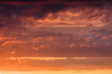 Orange clouds on the sky at the sunset moment