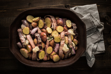 Lamb Loin Chops with Vegetables in Rustic Clay Dish Prepared for Roasting. Copy Space.