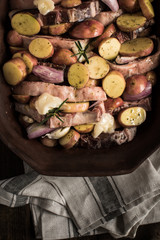 Lamb Loin Chops with Vegetables in Rustic Clay Dish Prepared for Roasting. Copy Space.