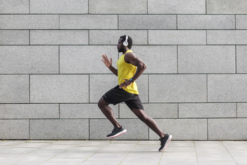 Fototapeta na wymiar Profile portrait of adult male runner with muscular body