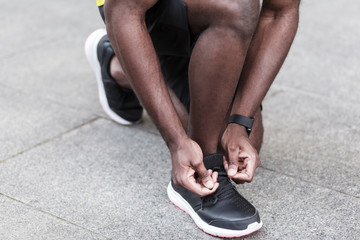 Closeup detail. Man ties up the shoelaces on sneakers before running