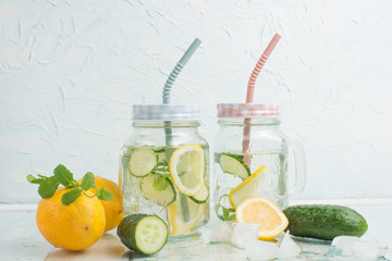 Rejuvenating drink, cocktail, tea, water with lemon, inbet, mint, cucumber in clear glass on a white background. Improvement and purification of the body. Detox.