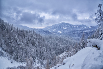 Fototapeta na wymiar Winter landscape with mountains and forests covered in snow